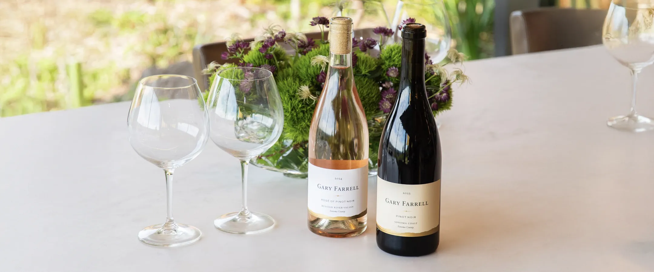 Sonoma Subscription wines on a table with glasses and flowers