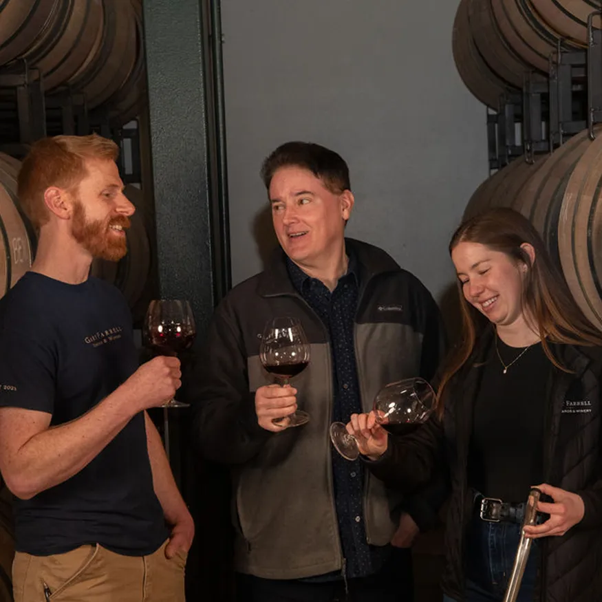 Winemaking team drinking red wine