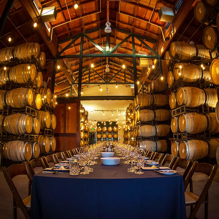Barrel room at Gary Farrell Vineyards set up for a long table dinner