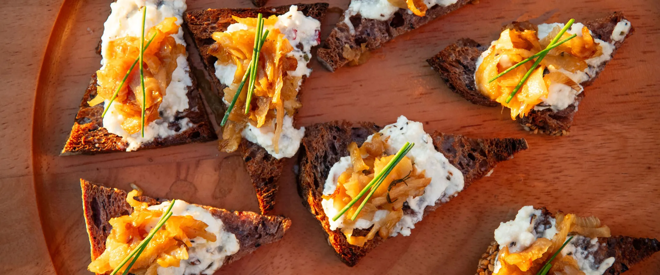 Goat Cheese & Caramelized Leek Crostinis on Dark Rye