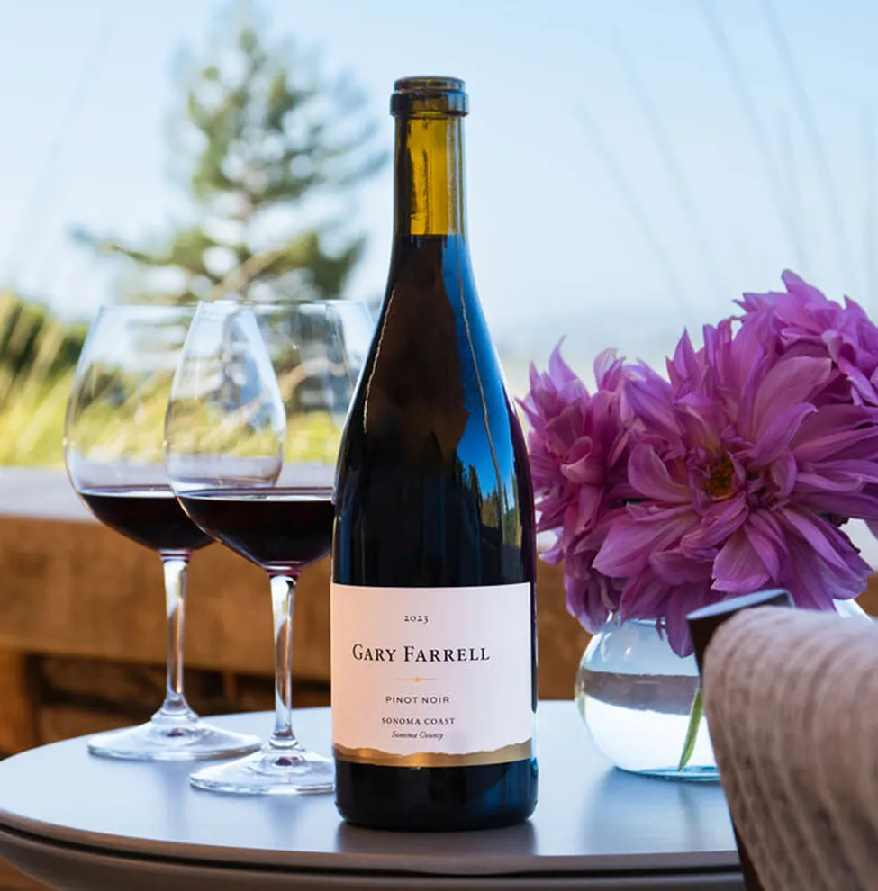 Bottle of wine from The Sonoma Selection on a table with glasses and flowers