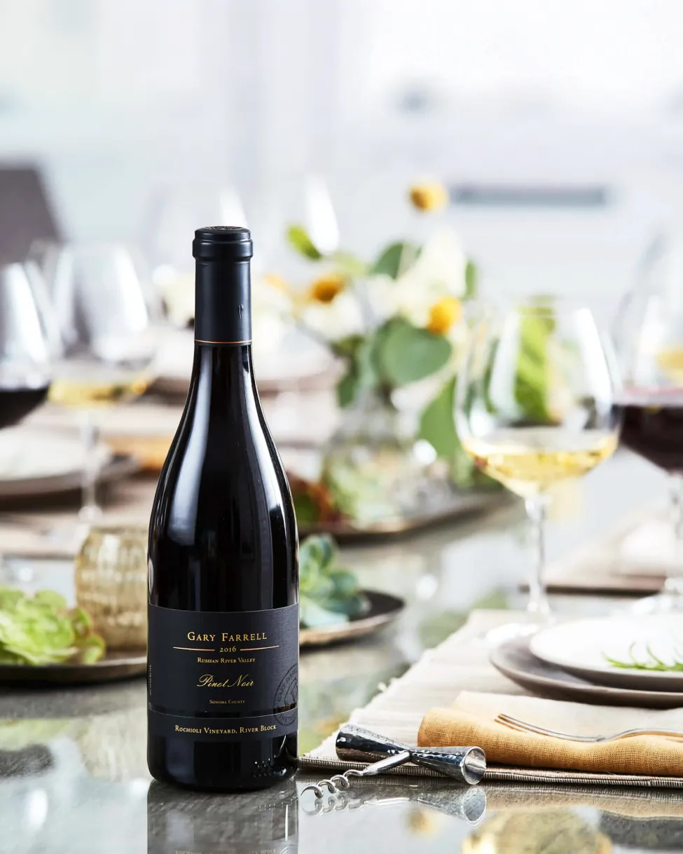 Bottle of Gary Farrell Rochioli Pinot Noir on a beautifully appointed dinner table