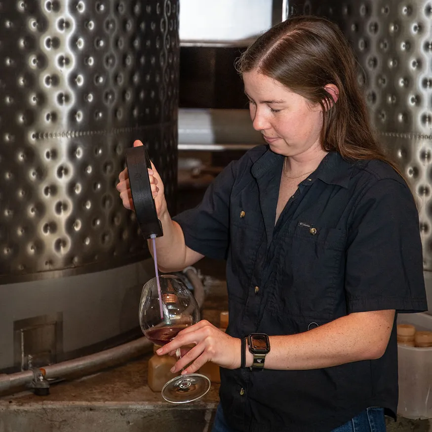 Meaghan Hodge sampling wine from a barrell