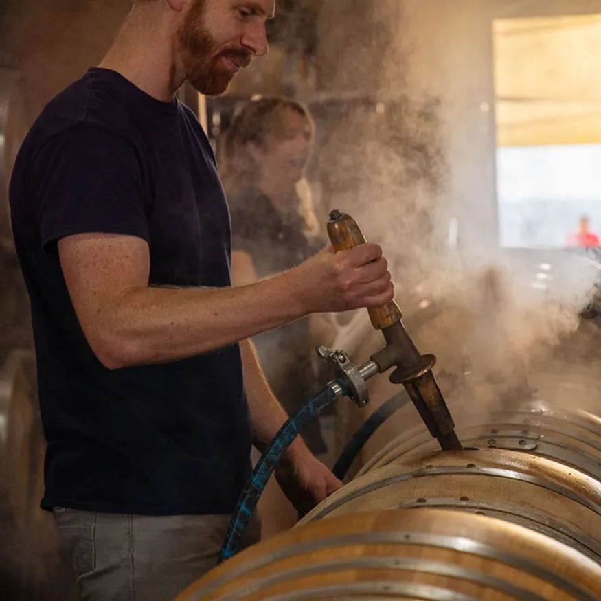 Peter Treleaven using a wine thief