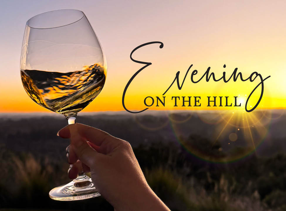 Swirling wine glass with sunset on the horizon. Evening on the Hill at Gary Farrell Winery