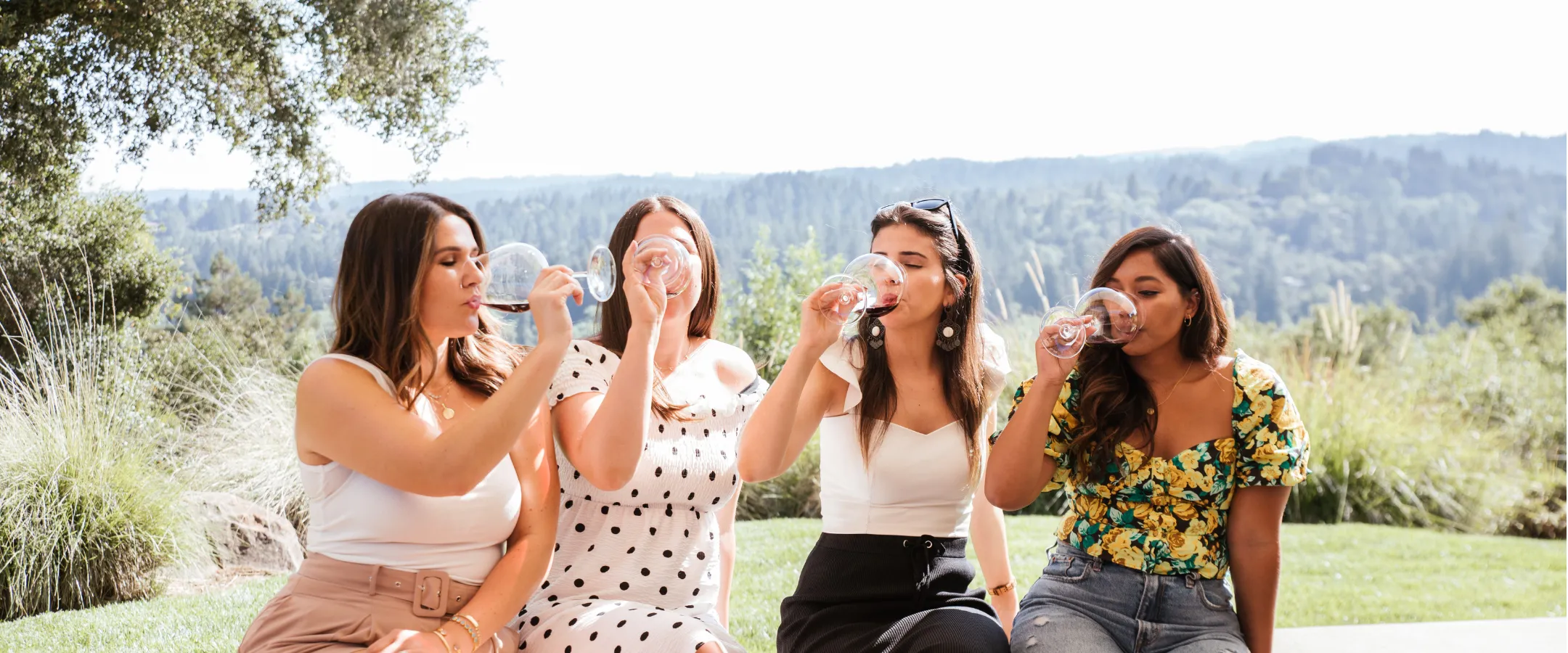 Four women drinking wine outdoors at Gary Farrell Winery