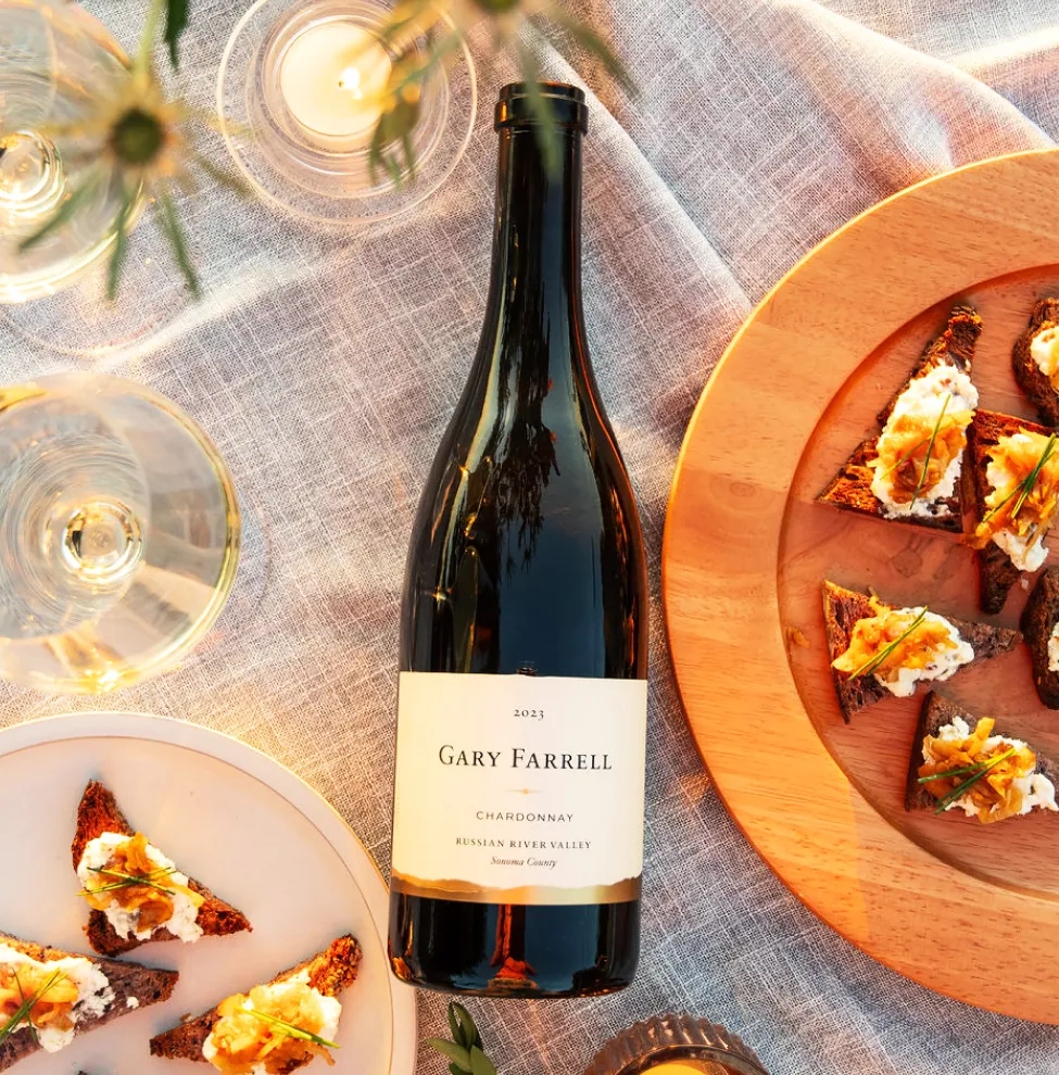 Closeup of Gary Farrell Russian River Valley Chardonnay bottle with canapés