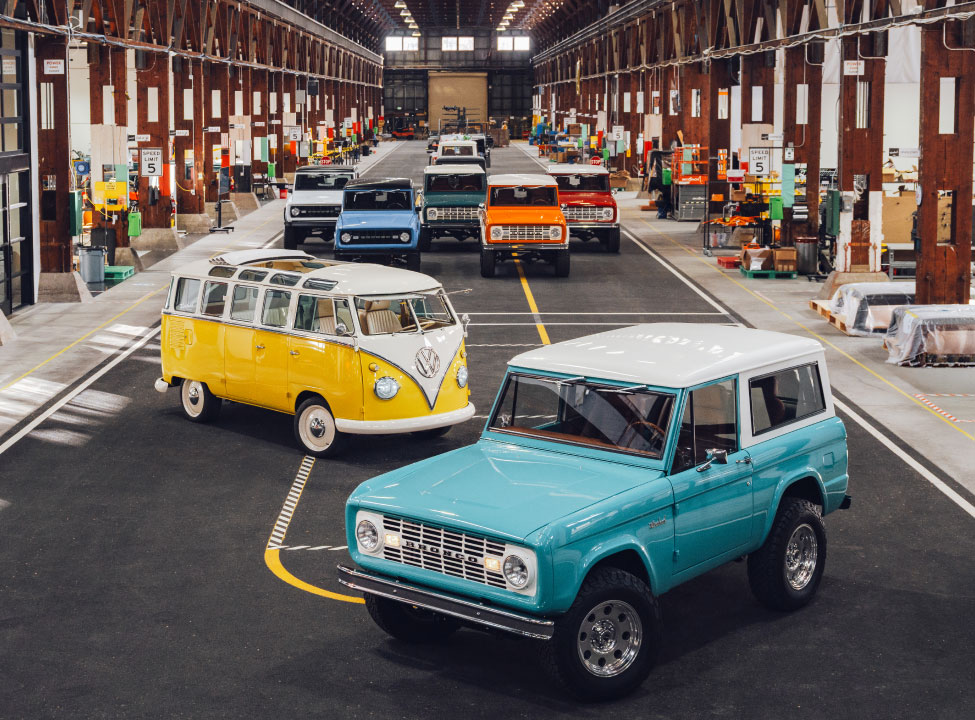 Classic cars restored by Kindred Mototorworks displayed in their workshop.